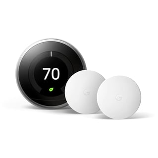 Google nest learning thermostat is a glass circular shape and has several circular white sensors as well to assist it. 