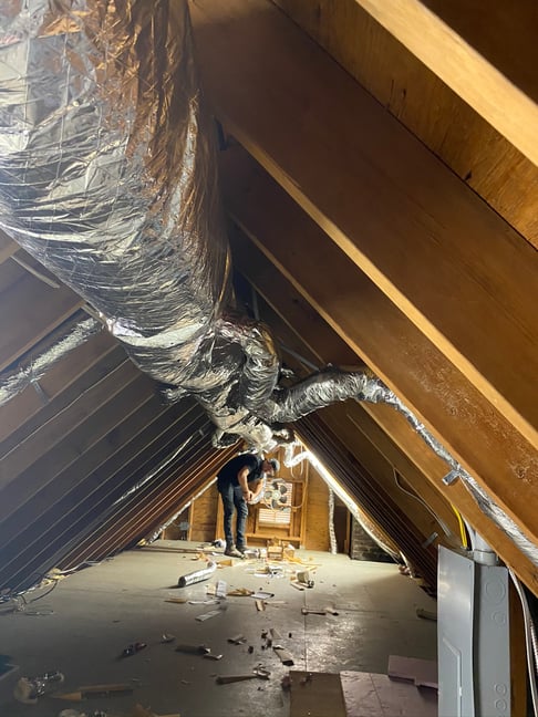 Ductwork along the ceiling of the attic.