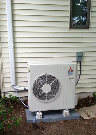 Mitsubishi heat pump outside Bristol home.