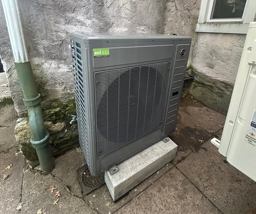 New Ruud RD18 modulating heat pump installed outside a Chestnut Hill, Philadelphia home.