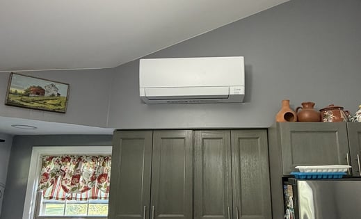 Mitsubishi Electric mini-split indoor unit installed in the kitchen of a split-level home.
