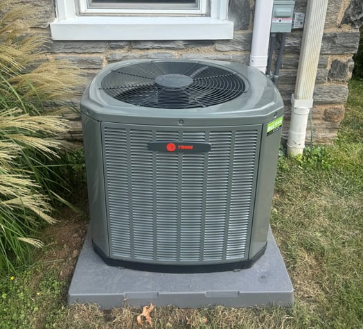 Outside condenser for the high-velocity air-conditioning system installed at an early-1900s home.