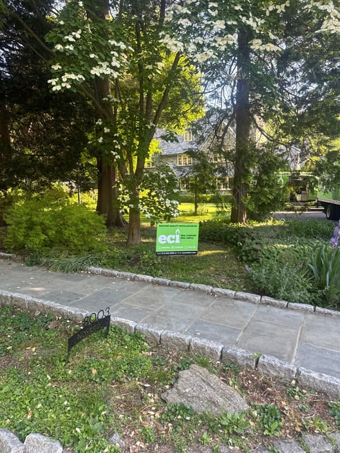ECI Comfort yard sign outside a home upgraded with a Unico high-velocity system and Ruud two-stage heat pump.