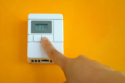 Person adjusting their thermostat constantly due to discomfort in their home. 