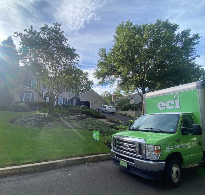 Front exterior of a Doylestown, PA home upgraded from oil heat to a cold-climate heat pump with propane backup heating.
