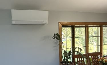 Mitsubishi Electric mini-split indoor unit installed in the open living area of a split-level home.