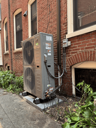 This Ruud variable speed heat pump sits on the side of Eliza's house